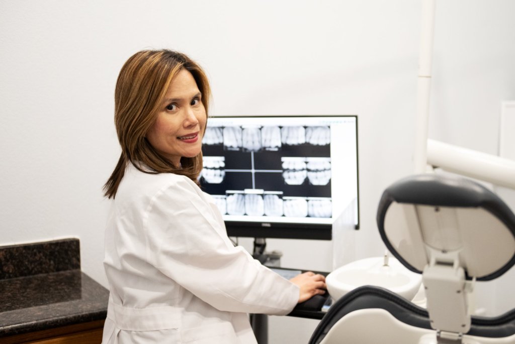 Photo of Dr. Marie Bugayong looking at a patient's x-ray