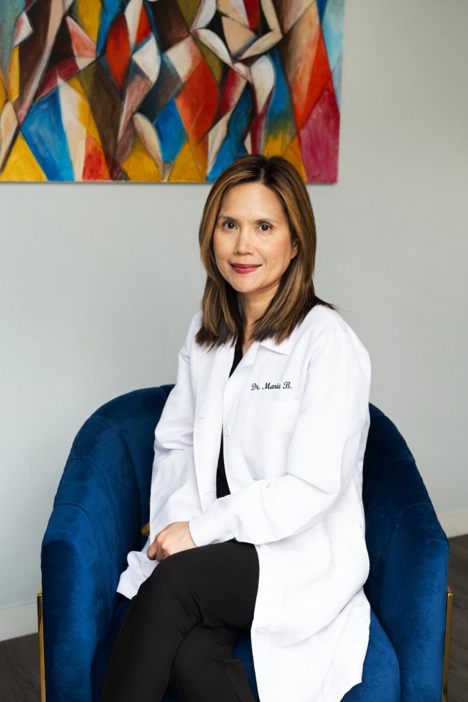 Photo of Dr. Marie Bugayong sitting in a blue chair
