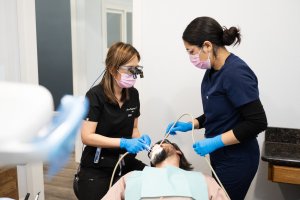 Photo of Dr. Marie Bugayong and a staff member working with a patient